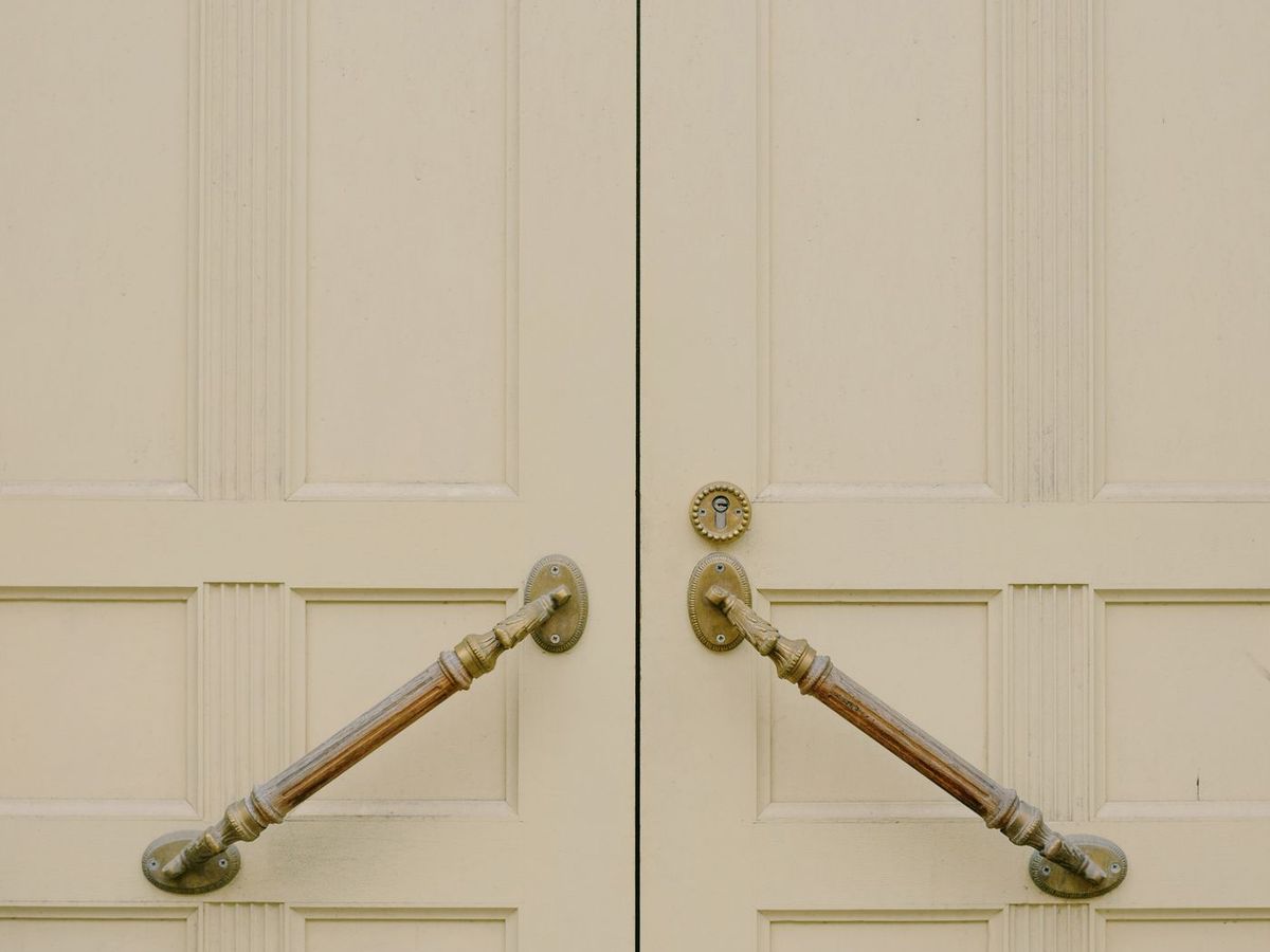 Brass pull handles fitted to a pair of panelled door shutters
