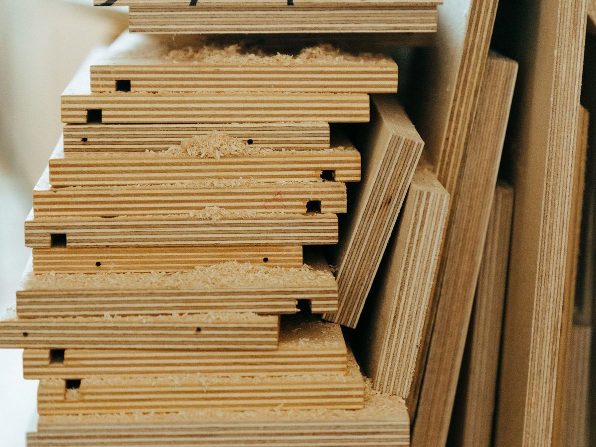 Plywood sheets stacked edge-on, with the ply layers visible along each edge