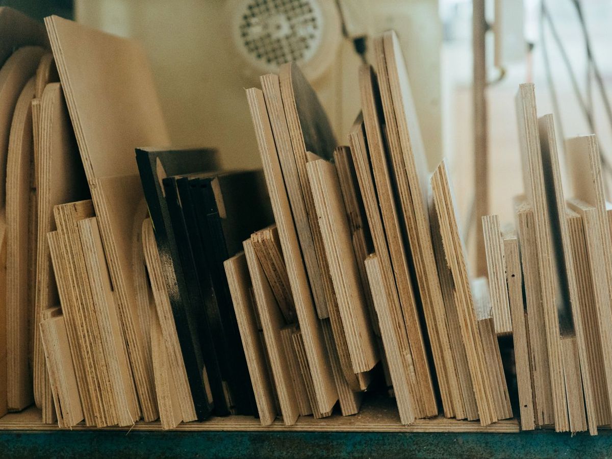 Offcut plywood sheets stood on edge, the ply layers visible along every edge