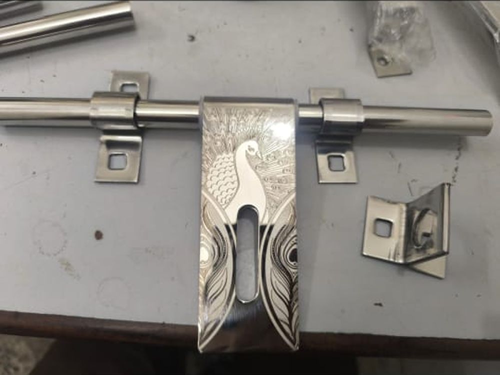 An engraved stainless steel aldrop with its fixing plates, from our hardware counter