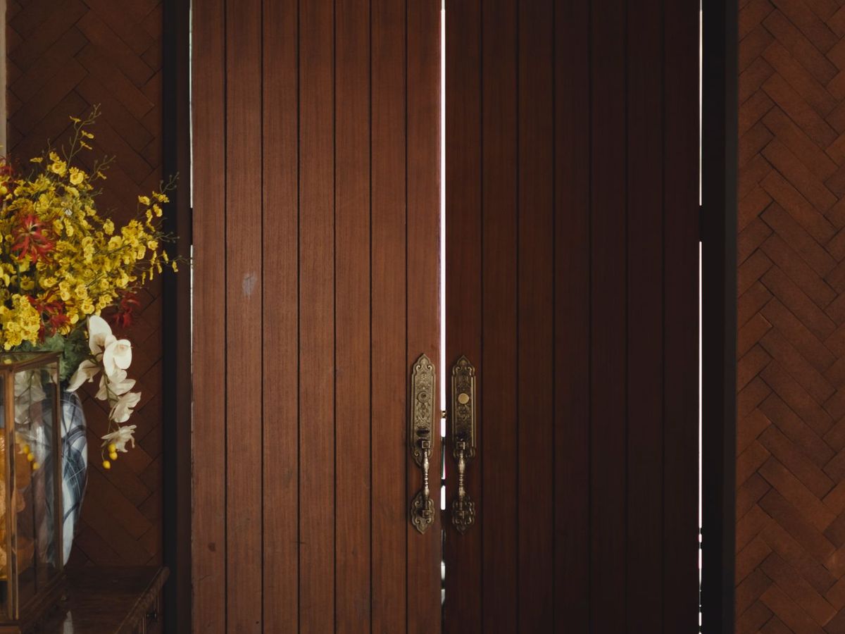 A polished hardwood double door hung in a finished entrance