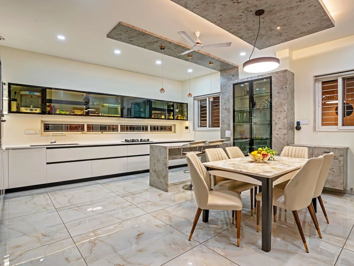Modular kitchen with laminated shutters, opening onto a dining area