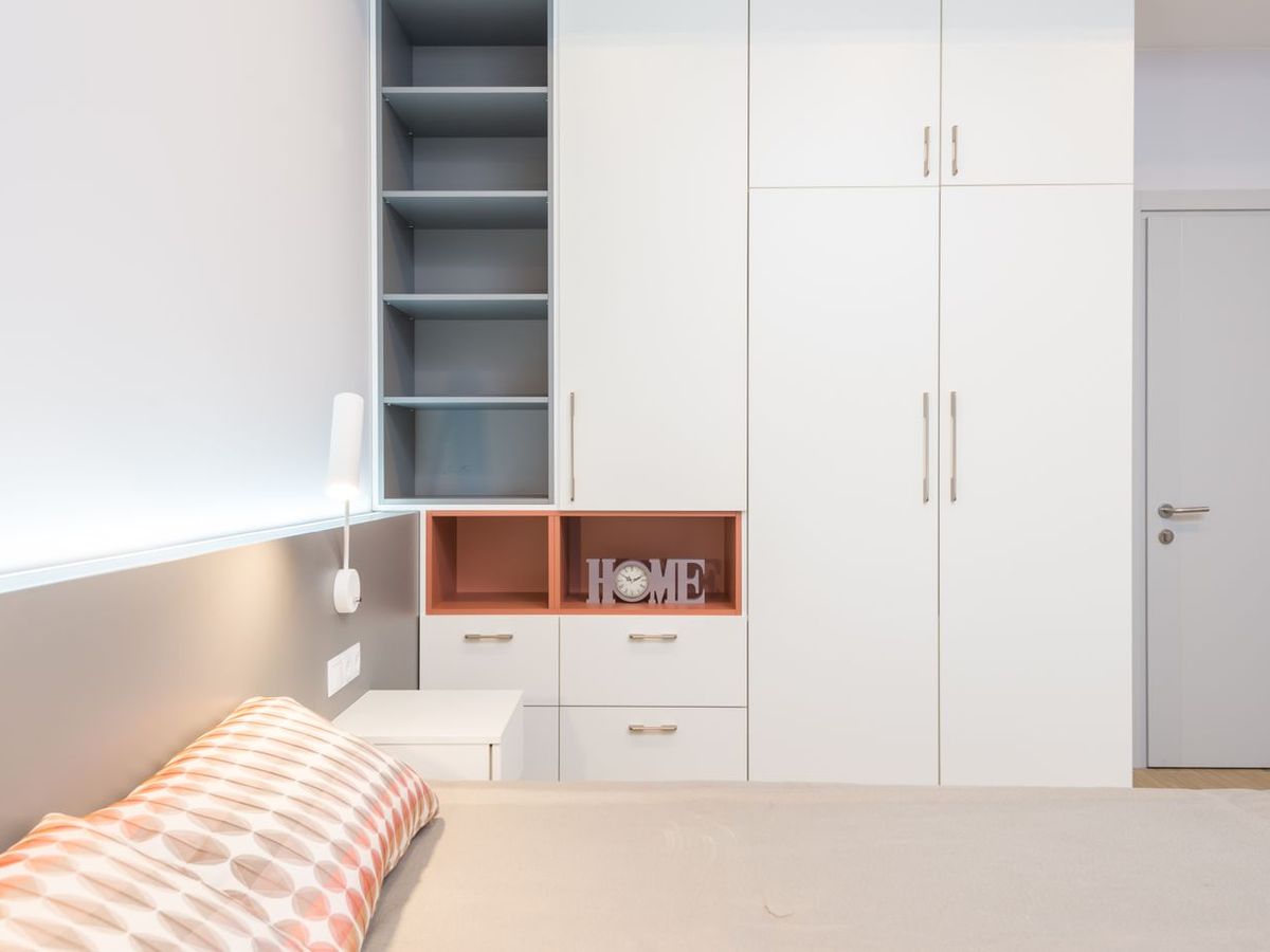 Full-height fitted wardrobes with open shelving in a bedroom