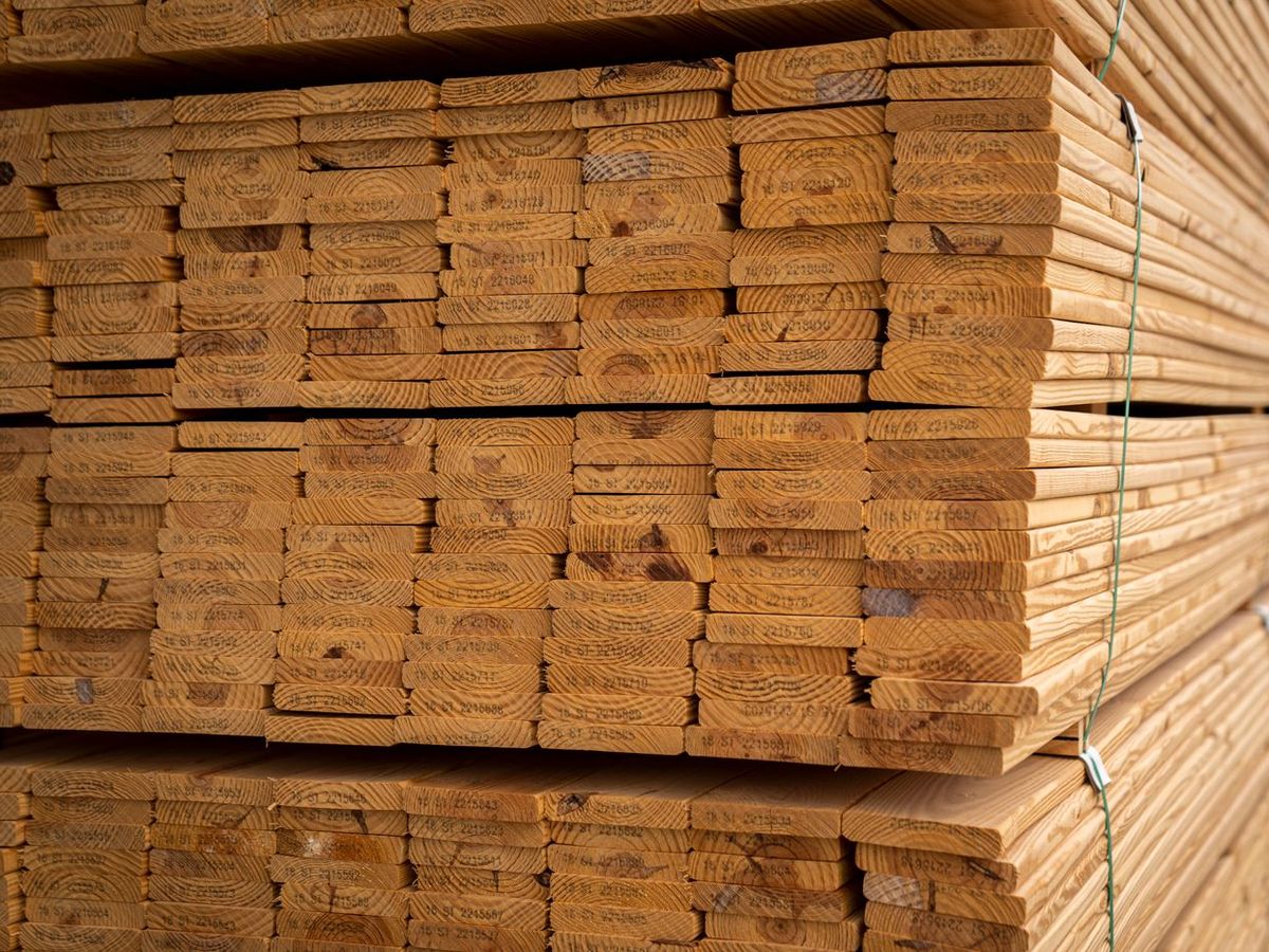 Sawn timber sections banded and stacked by size in a yard